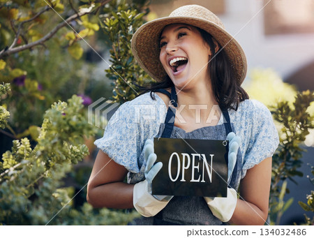 Happy, nursery and open with a woman holding a sign outside of shop for gardening or landscaping. Small business, garden center and an excited young female entrepreneur opening her new floral store 134032486