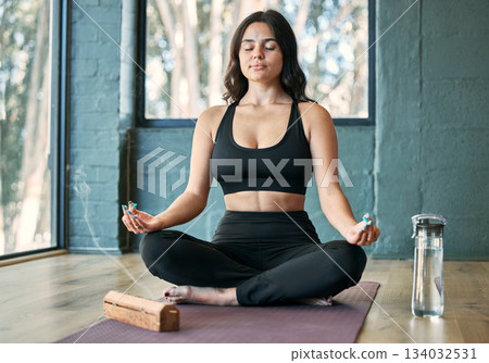 Yoga, lotus meditation and woman in gym for health, wellness and mindfulness exercise. Pilates, zen chakra and calm female yogi meditate for spiritual training, holistic workout or peace with incense 134032531