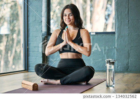 Namaste, yoga and portrait smile of woman in gym for health, wellness and exercise. Pilates, meditation and happy female yogi with prayer hands for training, exercising and meditate with incense. 134032562