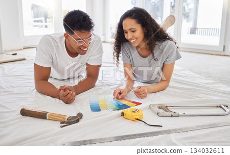 Paint, renovation and choice with a couple in their new home together for a remodeling project. Construction, real estate or property improvement with a man and woman looking at a color pallet Paint, renovation and choice with a couple in their new home together for a remodeling project. Construction, real estate or property improvement with a man and woman looking at a color pallet 134032611