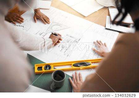 Hands, collaboration and construction with a building team working in their office on design from above. Teamwork, architecture or blueprint with an architect, designer and engineer at work together Hands, collaboration and construction with a building team working in their office on design from above. Teamwork, architecture or blueprint with an architect, designer and engineer at work together 134032629