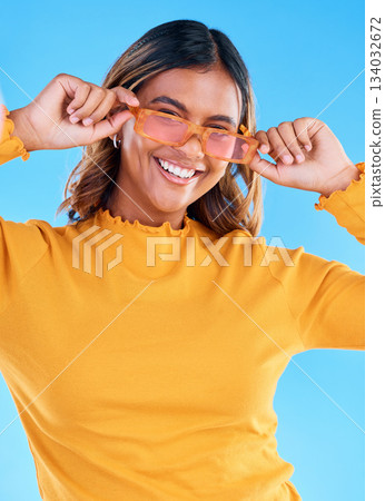 Fashion glasses, teen smile and happy woman with clothes, luxury designer brand or casual outfit style. Gen z summer aesthetic, teenager face portrait and young female model on blue background studio Fashion glasses, teen smile and happy woman with clothes, luxury designer brand or casual outfit style. Gen z summer aesthetic, teenager face portrait and young female model on blue background studio 134032672