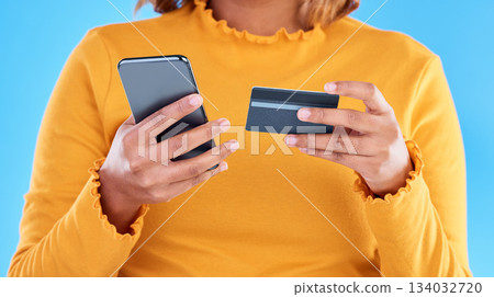 Woman hands, credit card and phone in studio for online shopping, digital fintech payment and customer money. Closeup female, ecommerce and mobile banking for finance, cash economy or sales promotion Woman hands, credit card and phone in studio for online shopping, digital fintech payment and customer money. Closeup female, ecommerce and mobile banking for finance, cash economy or sales promotion 134032720
