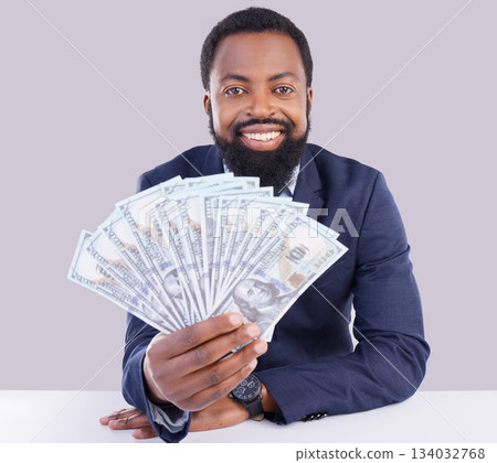 Portrait, cash and economy with a business black man in studio on a gray background as a lottery winner. Money, accounting and finance with a male employee holding dollar bills for investment 134032768