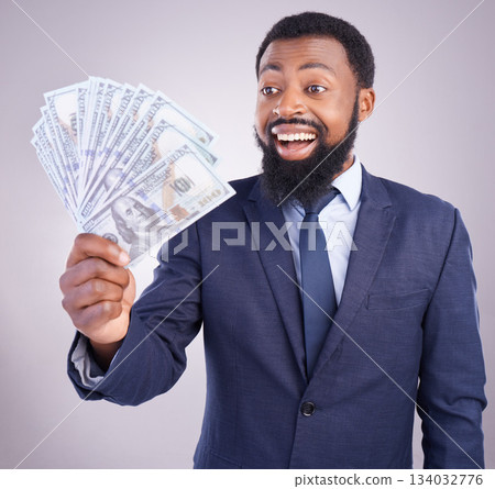 Wow, cash and investment with a business black man in studio on a gray background as a lottery winner. Money, accounting and finance with a male employee holding dollar bills for the economy Wow, cash and investment with a business black man in studio on a gray background as a lottery winner. Money, accounting and finance with a male employee holding dollar bills for the economy 134032776