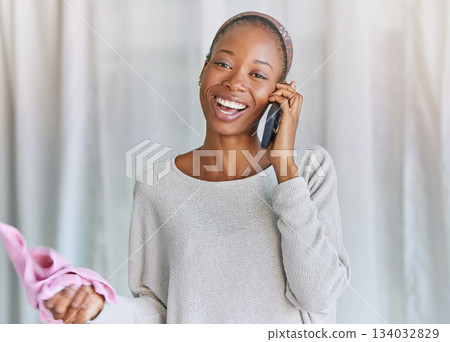 Black woman, phone call and portrait with a smile for communication and connection. Female model with a smartphone for conversation with network and contact laughing and cleaning space in living room Black woman, phone call and portrait with a smile for communication and connection. Female model with a smartphone for conversation with network and contact laughing and cleaning space in living room 134032829