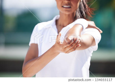 Tennis, sports woman and elbow injury with pain, first aid emergency and medical health risk. Closeup arm of female athlete with accident on training court, fitness mistake and injured muscle problem Tennis, sports woman and elbow injury with pain, first aid emergency and medical health risk. Closeup arm of female athlete with accident on training court, fitness mistake and injured muscle problem 134033117