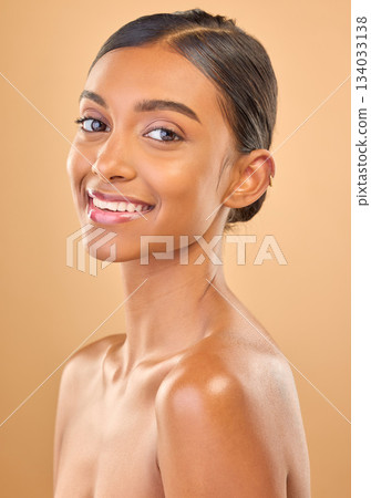 Smile, beauty and portrait skincare of a woman isolated on a studio background. Happy, beautiful and an Indian model with a glow from cosmetics, healthy skin and smooth complexion on a backdrop Smile, beauty and portrait skincare of a woman isolated on a studio background. Happy, beautiful and an Indian model with a glow from cosmetics, healthy skin and smooth complexion on a backdrop 134033138