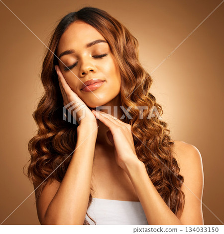 Beauty, cosmetics and woman with hair care, shine and volume against a brown studio background. Female, lady or style for confidence, natural glow and salon treatment with luxury, aesthetic or growth 134033150