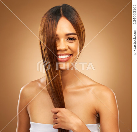 Haircare, smile and portrait of woman in studio holding strong hair in hand with texture and shine. Happy model, mockup and beauty, healthy straight hairstyle with keratin product on brown background Haircare, smile and portrait of woman in studio holding strong hair in hand with texture and shine. Happy model, mockup and beauty, healthy straight hairstyle with keratin product on brown background 134033162