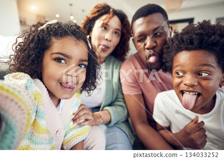 Happy, tongue and selfie with black family in living room for social media, bonding and funny face. Happiness, picture and care with parents and children at home for memory, support and weekend Happy, tongue and selfie with black family in living room for social media, bonding and funny face. Happiness, picture and care with parents and children at home for memory, support and weekend 134033252