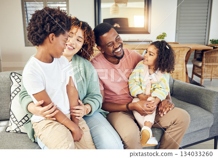 Happy family, embrace and laugh on a sofa, cheerful and smile while bonding and relax in their home. Laughing, children and parents on couch together, hug and loving in a living room on weekend Happy family, embrace and laugh on a sofa, cheerful and smile while bonding and relax in their home. Laughing, children and parents on couch together, hug and loving in a living room on weekend 134033260