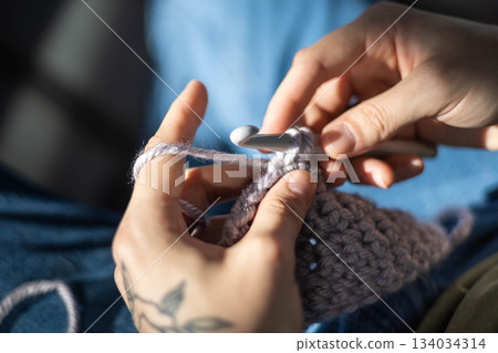 Modern hipster man crochet handmade hobby use hook knitting needles and wool yarn top view closeup 134034314