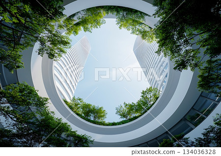 Circular View of Modern Architecture Surrounded by Greenery and Blue Sky from Below 134036328