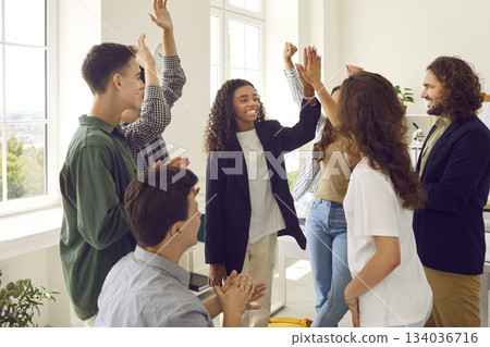 Group of happy diverse teenage students together with teacher having fun at school Group of happy diverse teenage students together with teacher having fun at school 134036716
