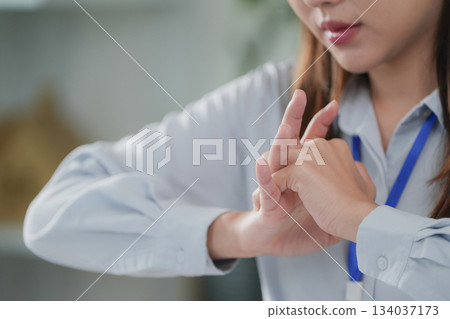Office Syndrome: Woman stretching her fingers to relieve tension 134037173