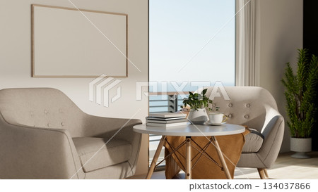 Round stool table and sofa or armchair in front of white wall with empty frame near balcony entrance Round stool table and sofa or armchair in front of white wall with empty frame near balcony entrance 134037866