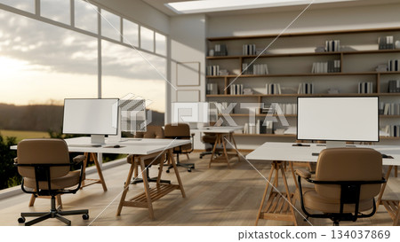 White screen computers on table with swivel chairs on parquet floor in the office with glass wall. 134037869