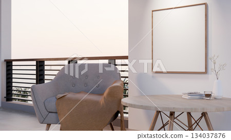 Blank wooden frame hanging on white wall over a wooden table and armchair with blanket near balcony. Blank wooden frame hanging on white wall over a wooden table and armchair with blanket near balcony. 134037876