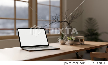Blank screen computer with a coffee cup, books and decors on wooden table in the cafe or library. 134037881