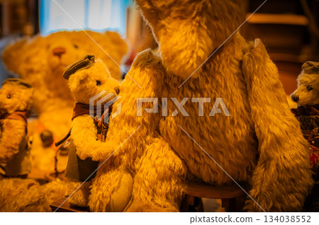 A warm scene with a teddy bear surrounded by Christmas goods 134038552
