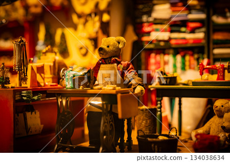 A warm scene with a teddy bear surrounded by Christmas goods 134038634