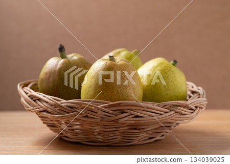 Fresh pear in basket on wooden background Fresh pear in basket on wooden background 134039025