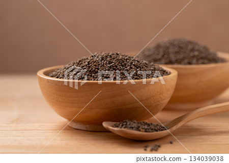 Dried perilla seed in a bowl with spoon on wooden background 134039038