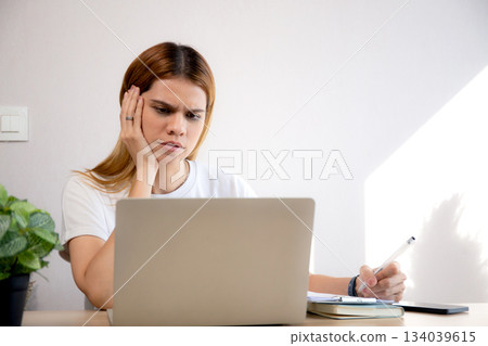 Young caucasian business woman working with laptop while thinking for planning financial on desk. 134039615