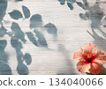 Hibiscus on a grey wooden table in the shade 134040066