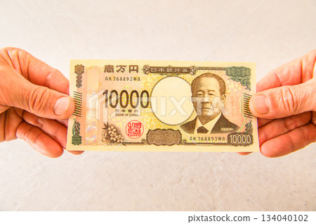 一張100美元鈔票和一張10000美元鈔票的側面特寫 134040102