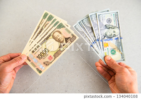 An angle shot of five $100 bills and five $10,000 bills An angle shot of five $100 bills and five $10,000 bills 134040108