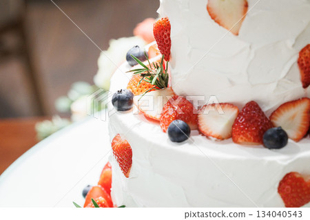 A picture of a big cream cake with lots of strawberries on top Wedding cake 134040543