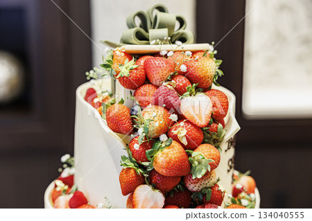 A picture of a big cream cake with lots of strawberries on top Wedding cake A picture of a big cream cake with lots of strawberries on top Wedding cake 134040555