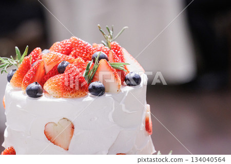 A picture of a big cream cake with lots of strawberries on top Wedding cake A picture of a big cream cake with lots of strawberries on top Wedding cake 134040564