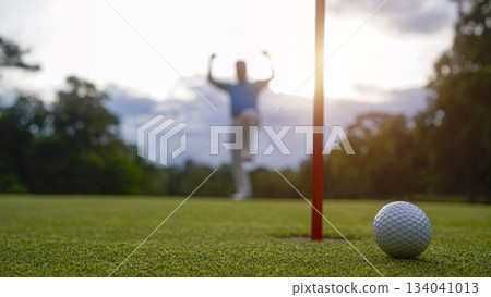Golf ball is on a green lawn in a beautiful golf course with morning sunshine. 134041013
