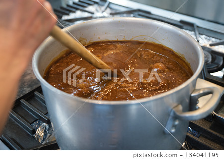 Curry simmering in a large pot Curry simmering in a large pot 134041195