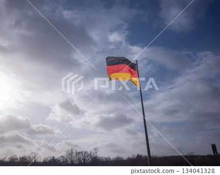 [Germany] The German flag waving in the cloudy sky of the capital Berlin 134041328