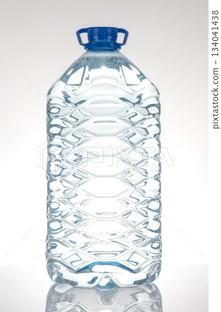 large plastic water bottles with blue caps and textured design 134041438