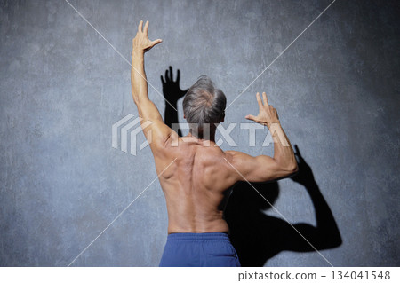 Muscular senior man posing, back view 134041548