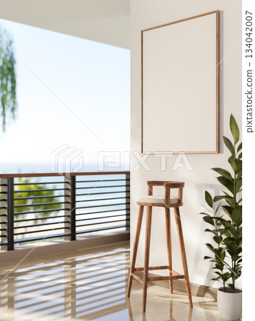 Blank frame hang on white wall over a wooden stool chair at balcony or terrace with scenery outside. 134042007