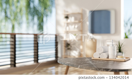 Marble stool table with towels and spa essentials in a bathroom with white wall of a sea view room. Marble stool table with towels and spa essentials in a bathroom with white wall of a sea view room. 134042014