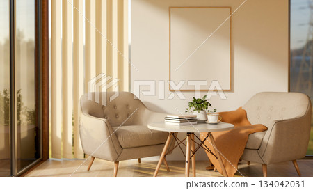 Armchairs and round table on wooden parquet floor in a white wall room with the blinds covered door. 134042031