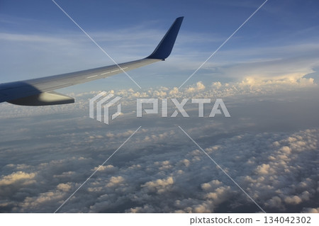 Detroit Airport, USA: Wings and sea of clouds after takeoff Detroit Airport, USA: Wings and sea of clouds after takeoff 134042302
