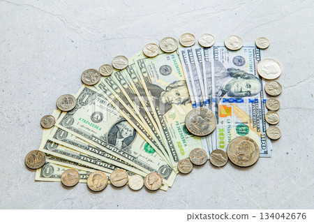 Flat lay 3 of 100, 20, and 1 dollar bills and US coins Flat lay 3 of 100, 20, and 1 dollar bills and US coins 134042676