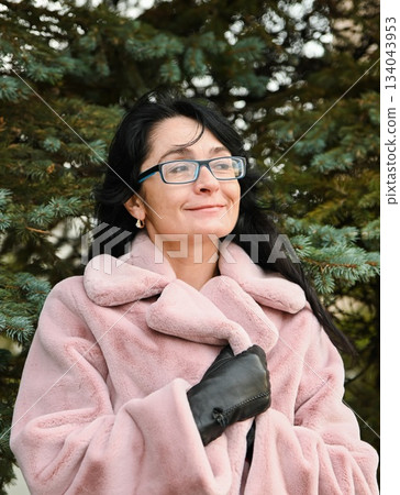 A Russian woman, 50 years old, standing outdoors with a soft smile, looking thoughtful and content, radiating calm insight, quiet confidence, and warm emotion. A Russian woman, 50 years old, standing outdoors with a soft smile, looking thoughtful and content, radiating calm insight, quiet confidence, and warm emotion. 134043953