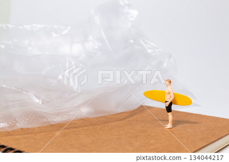 Miniature Surfer Confronting Plastic Waste 134044217