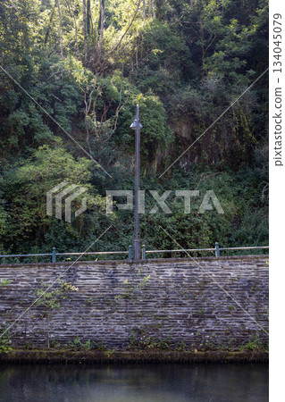 Esch-sur-Sure, Wiltz, Grand-Duche de Luxembourg, September 07, 2025, Calm water surrounded by lush Esch-sur-Sure, Wiltz, Grand-Duche de Luxembourg, September 07, 2025, Calm water surrounded by lush 134045079