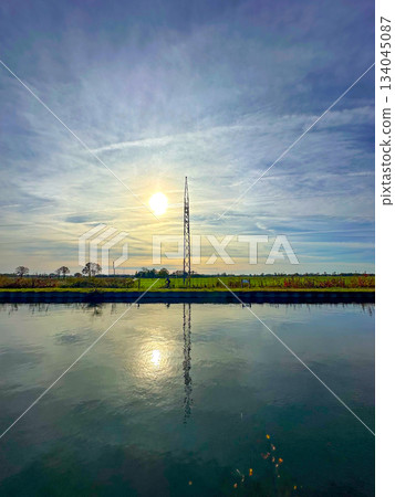 Reflective water captures tower and sky in tranquil clarity 134045087