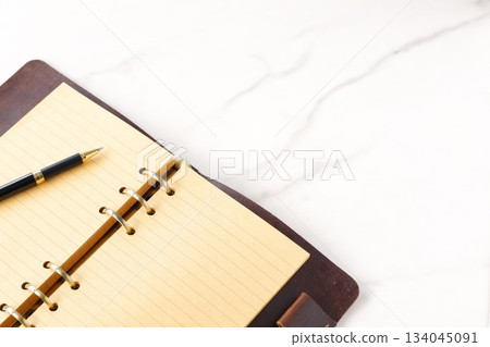 Image of a ring-type system organizer open while doing desk work Image of a ring-type system organizer open while doing desk work 134045091